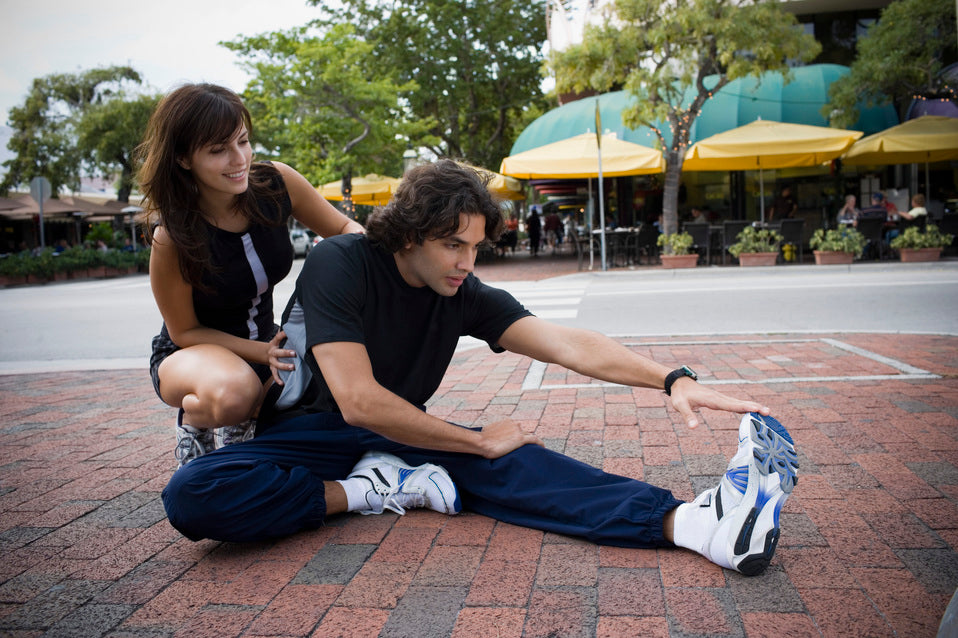 Man stretching his hamstring before a workout