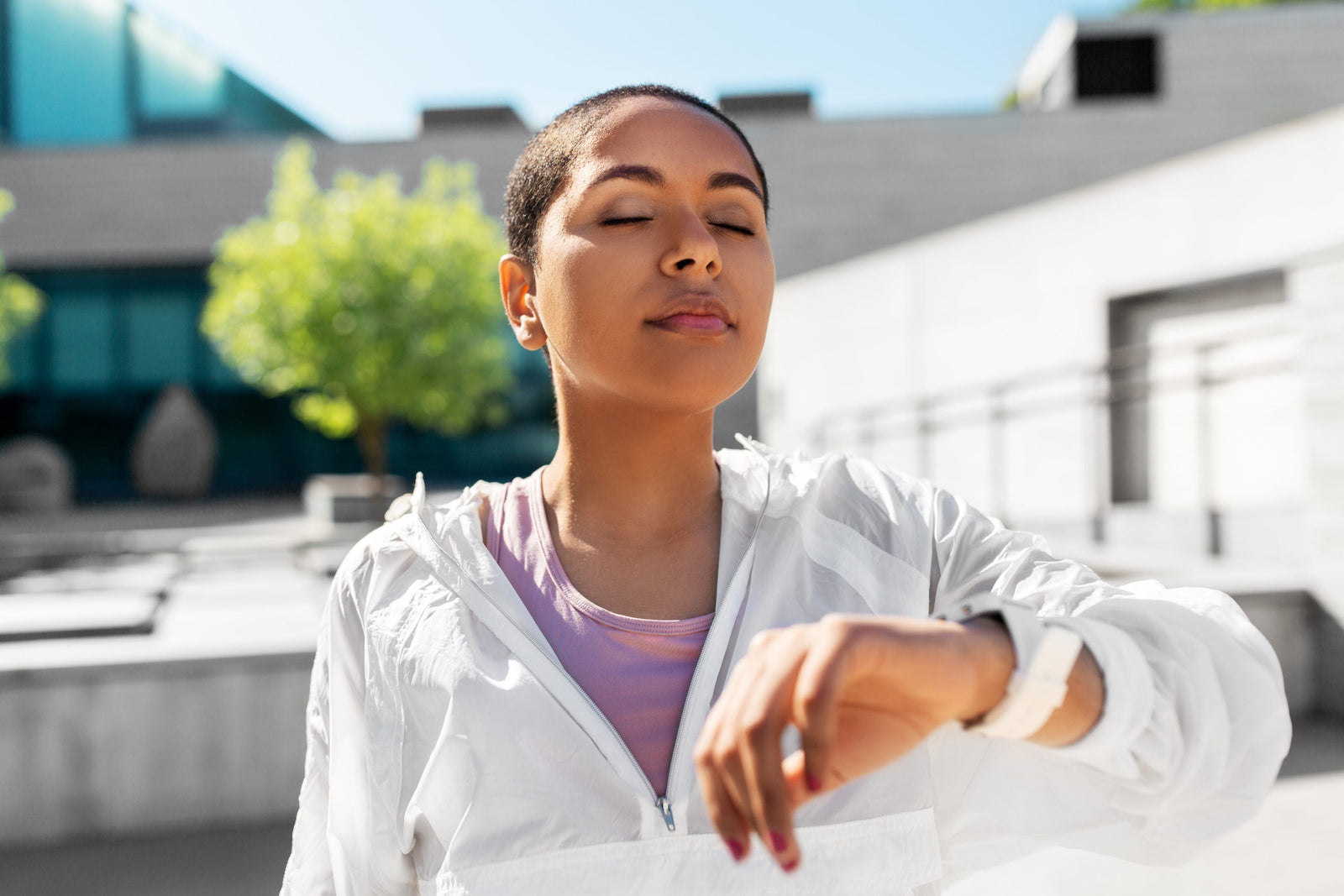 young black woman with smart watch breathing outdoors to illustrate 4-7-8 breathing for weight loss