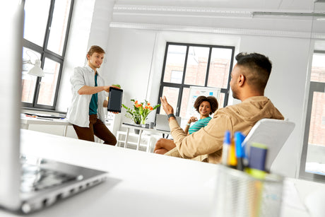 A man showing tablet to creative team at office to help illustrate Bariatric Surgery Recovery Time: Back to Work