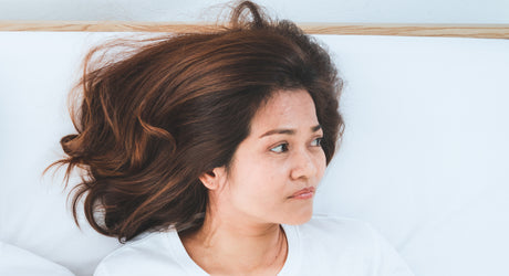 Frustrated woman lying down in bed to help illustrate Chemical Imbalance After Gastric Bypass