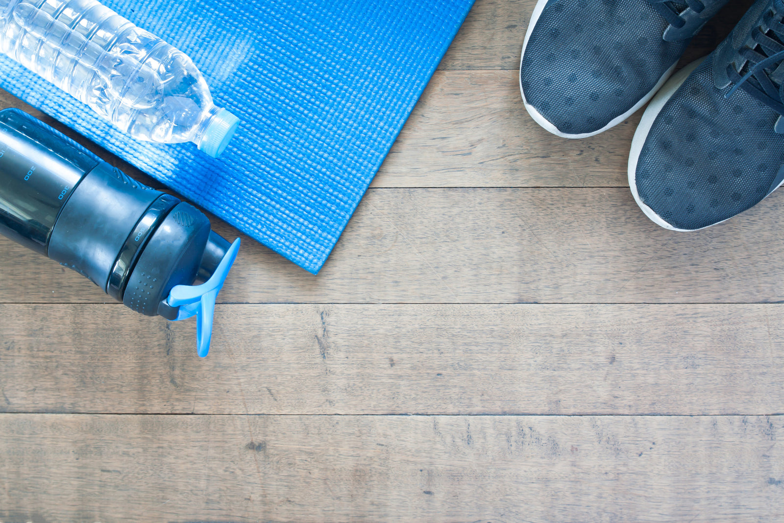 water bottles, exercise mat and running shoes to illustrate Cryotherapy Benefits Weight Loss