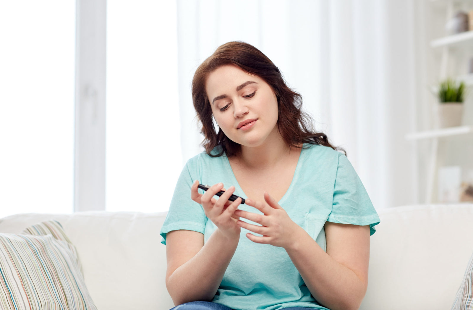A woman taking blood test by glucometer to illustrate How Does Bariatric Surgery Reverse Diabetes