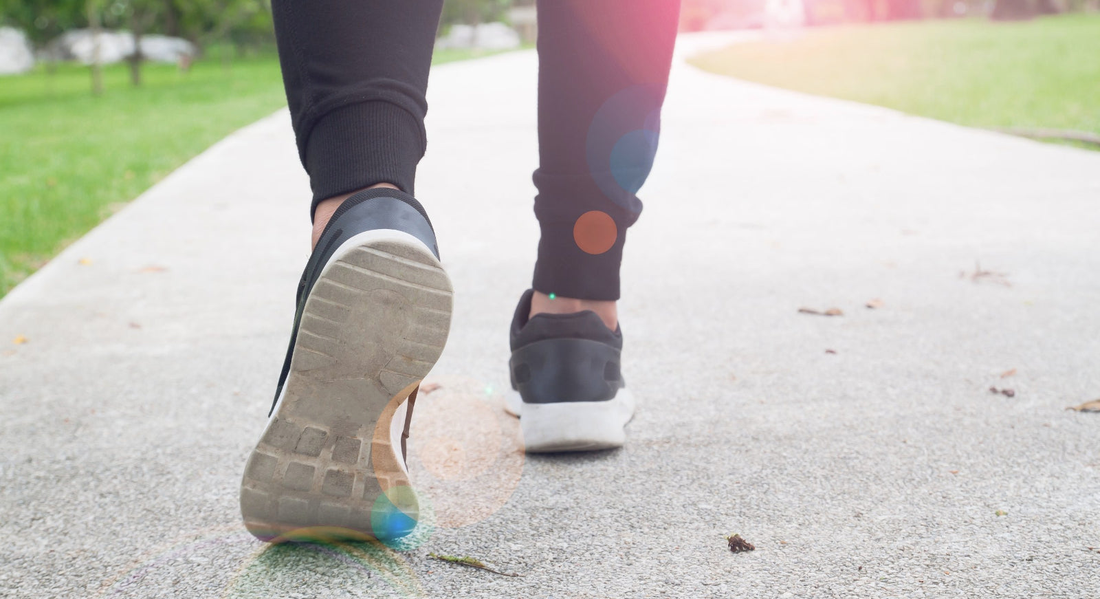 A close up of feet walking on a path to help illustrate Low Impact Workout for Obese Beginners.