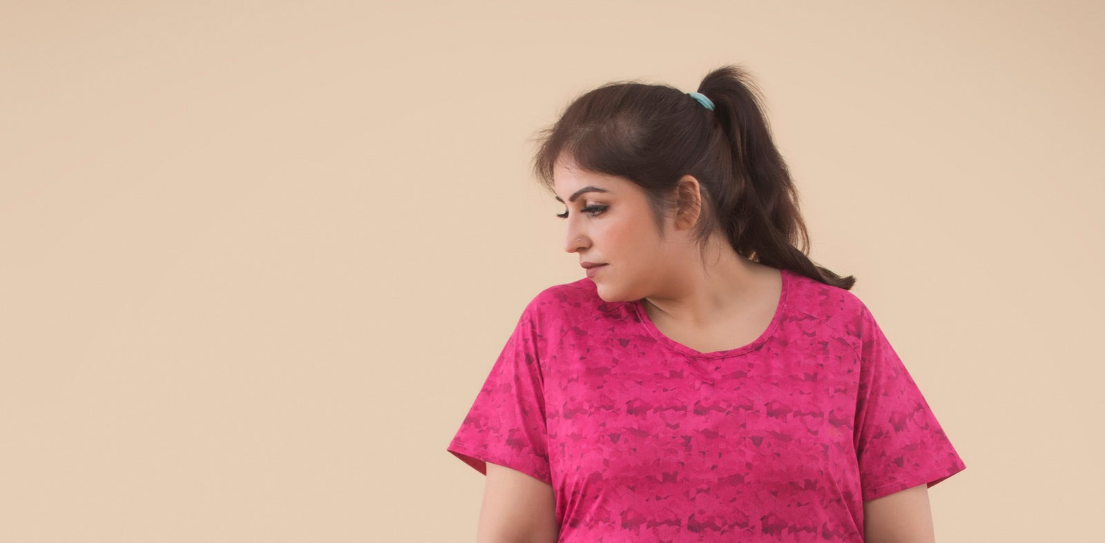 An overweight woman in a pink shirt looking to the right to help illustrate Do Vitamin Patches Work For Bariatric Patients and reasons for weight gain in females.