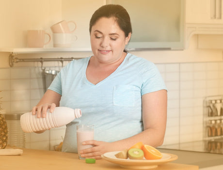 A woman pouring a liquid into a glass in her kitchen to help illustrate can I eat the night before gastric sleeve surgery and Bariatric Surgery vs. Dieting|Surgeons performing bariatric surgery to help illustrate Bariatric Surgery vs. Dieting