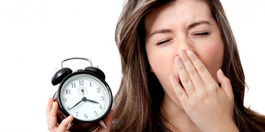 An image of a woman holding an alarm clock and covering her mouth as she yawns to illustrate sleep apnea and bariatric surgery and What are Weight-Related Comorbidities