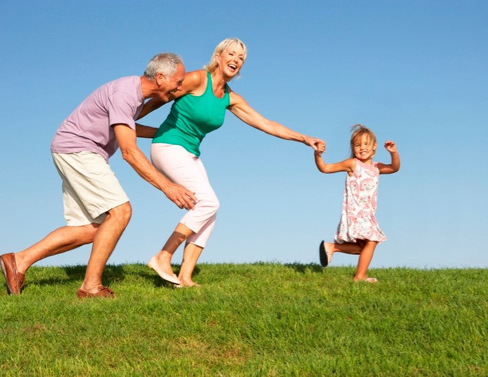 Older couple playing with grandchild.