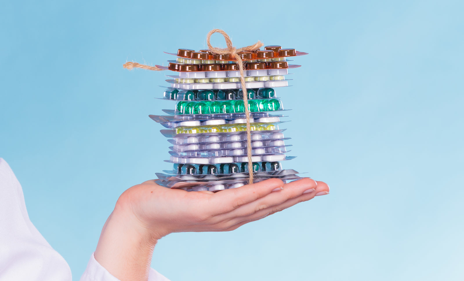 An upturned hand holding a bundle of pills to help illustrate Why Choose Bariatric Surgery Over Weight Loss Drugs?