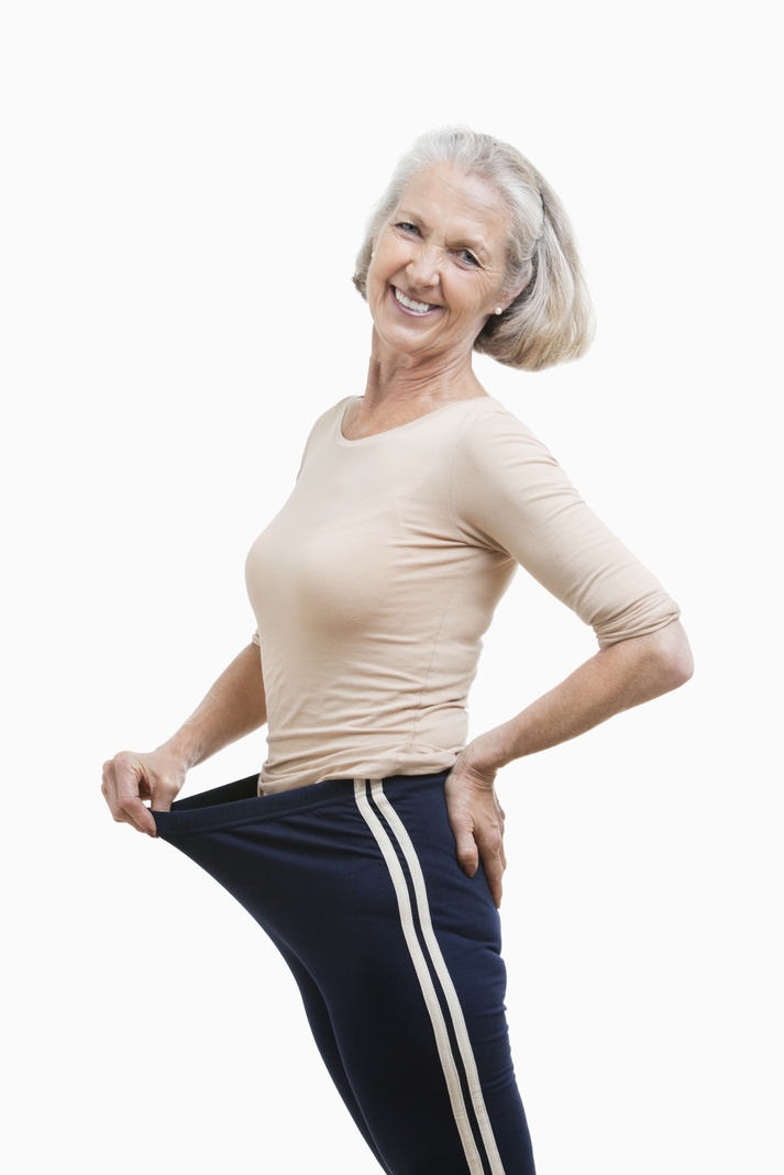 A woman with over-sized pants stands against a white background