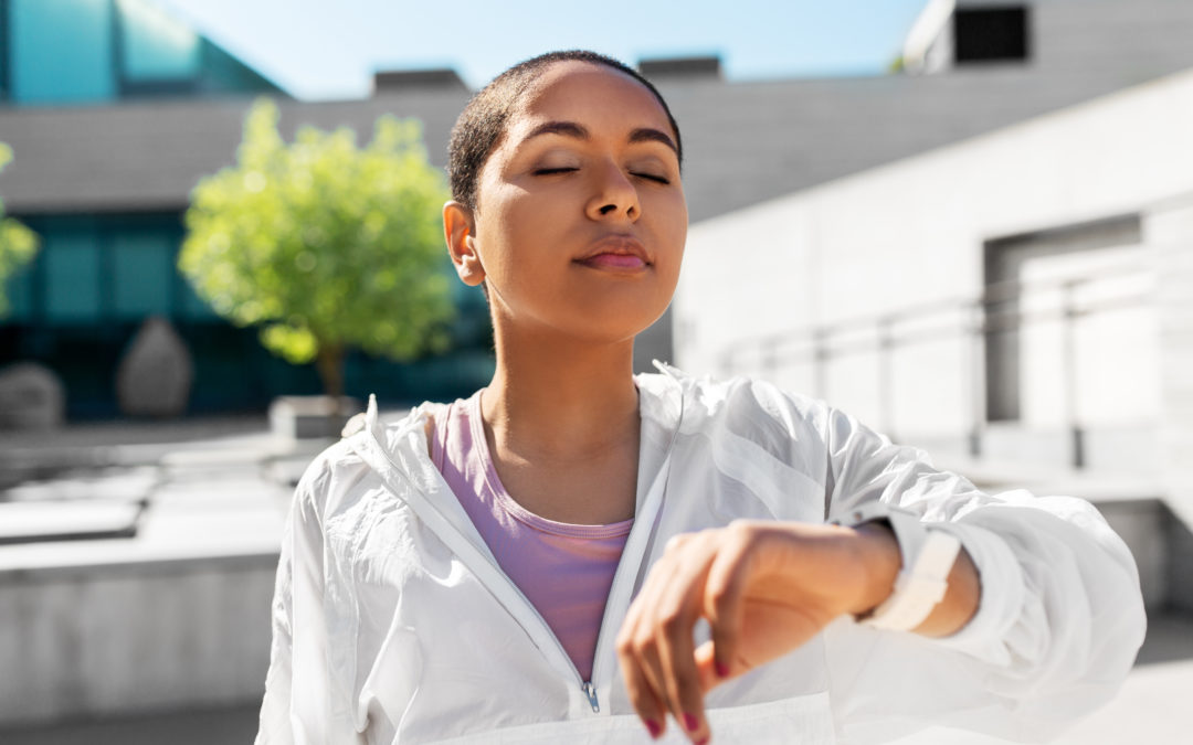 young black woman with smart watch breathing outdoors to illustrate 4-7-8 breathing and weight loss