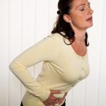 A woman experiencing the digestive issues after gastric sleeve surgery