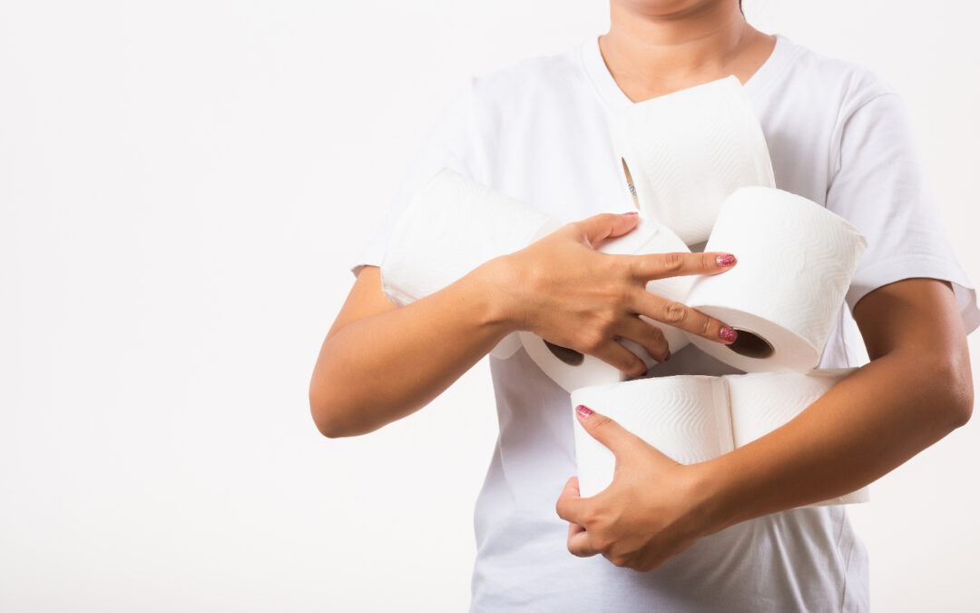 Someone in a white tshirt holding several rolls of toilet paper to help illustrate How Long Before You Poop After Gastric Sleeve