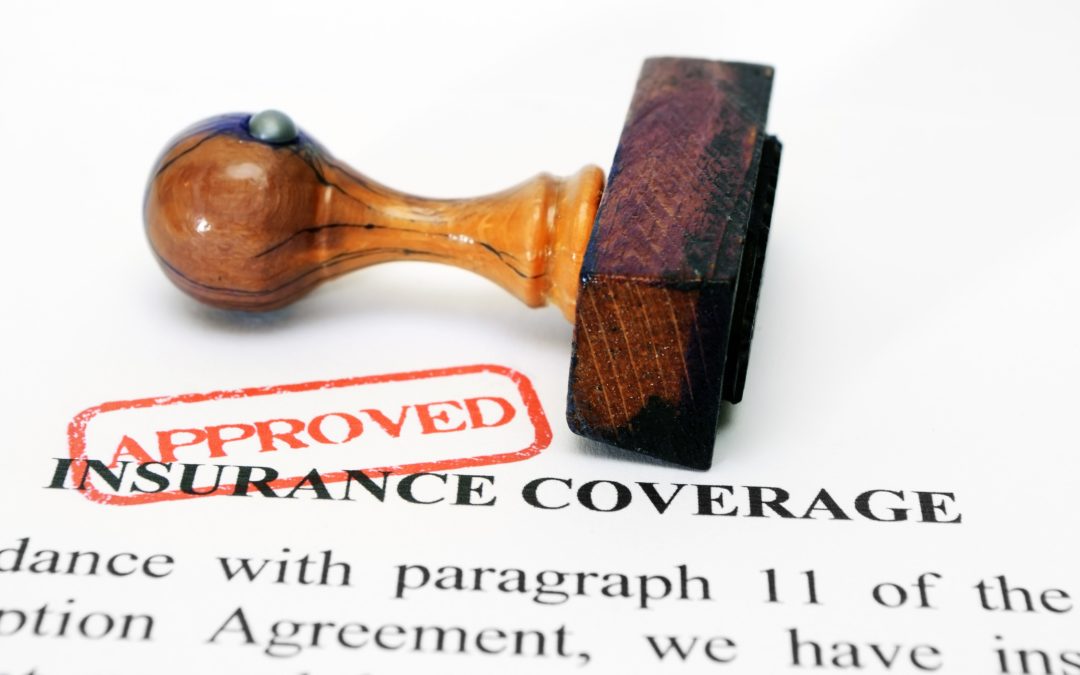 Insurance coverage and wooden approved stamp to illustrate How much does insurance pay for weight loss surgery