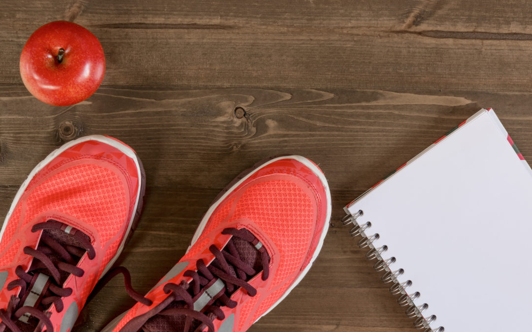 Women's shoes and a notebook for recording sporting achievements to illustrate How to get back on track after bariatric surgery