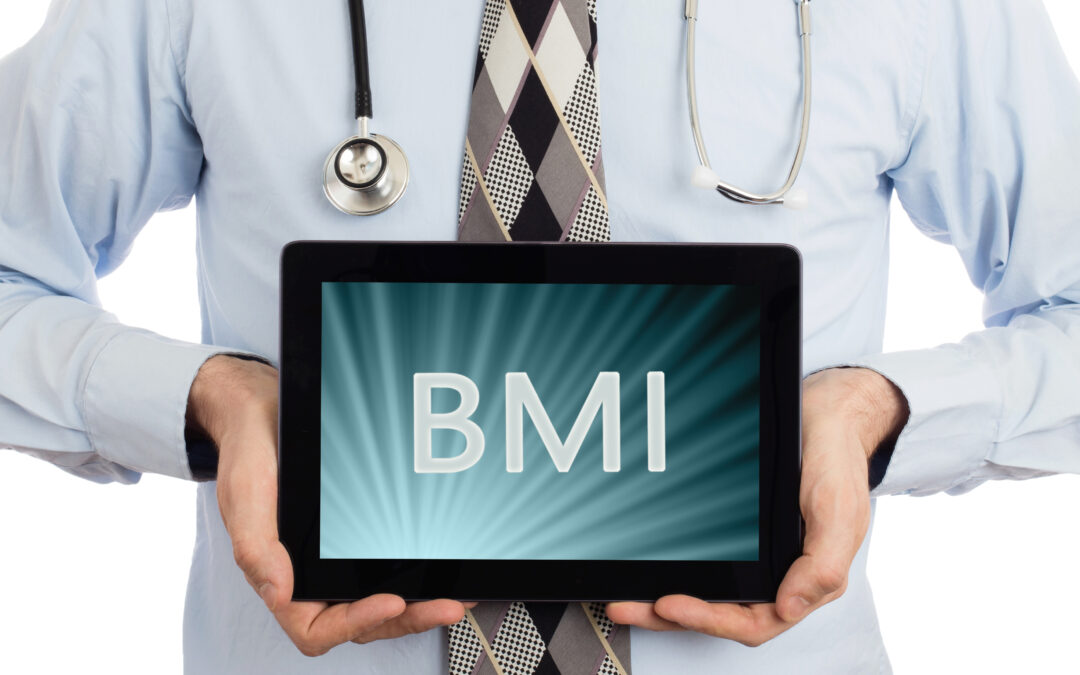Doctor, isolated on white background, holding digital tablet that says BMI to illustrate New BMI Guidelines and Weight-Loss Surgery Recommendations