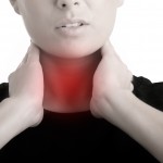 Image of woman holding her throat with thyroid issues