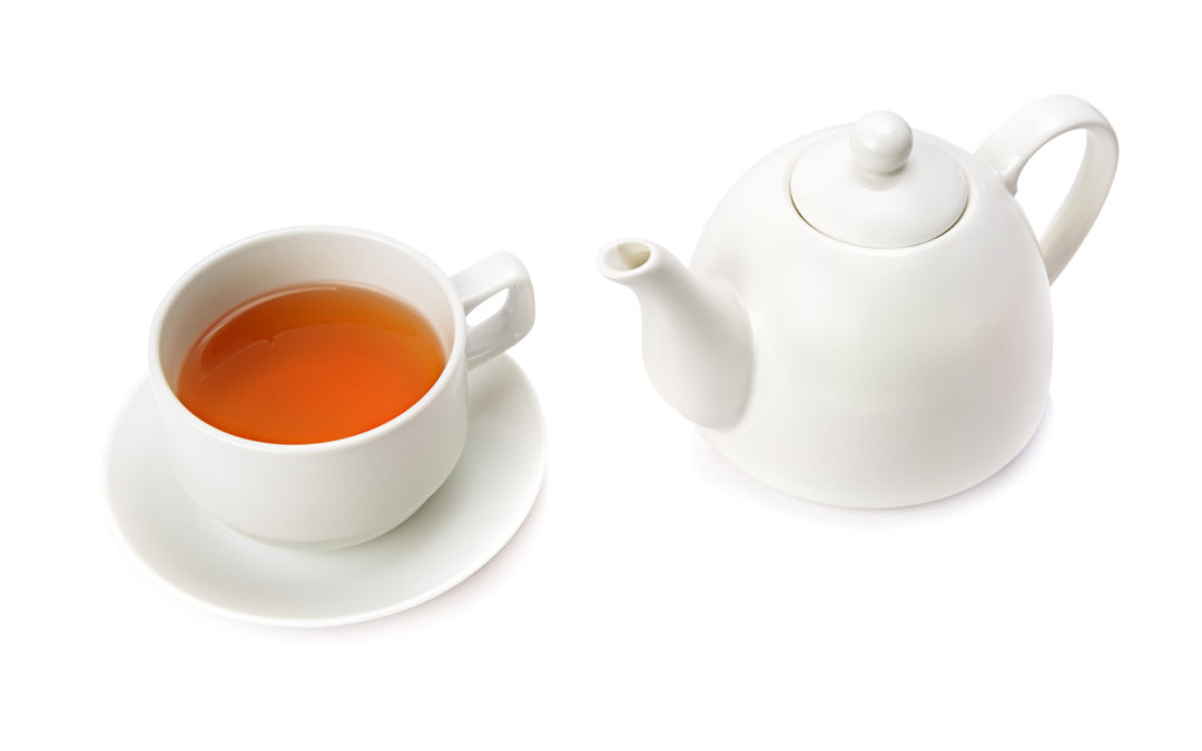 Cup of tea with white teapot on a white background