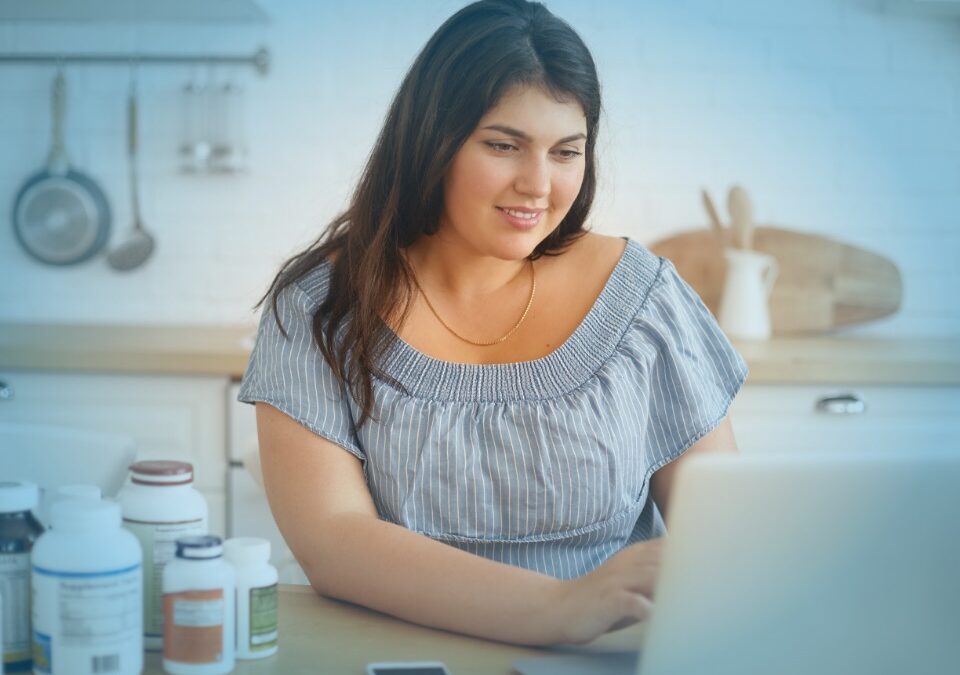 A woman researching weight loss surgery online to illustrate how to prepare for bariatric surgery.