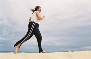 A woman follows an exercise regimen as prescribed by her personal trainer after recovering from weight loss surgery