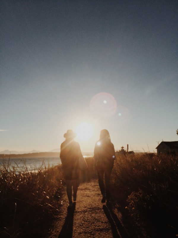 two women on a walk at sunset
